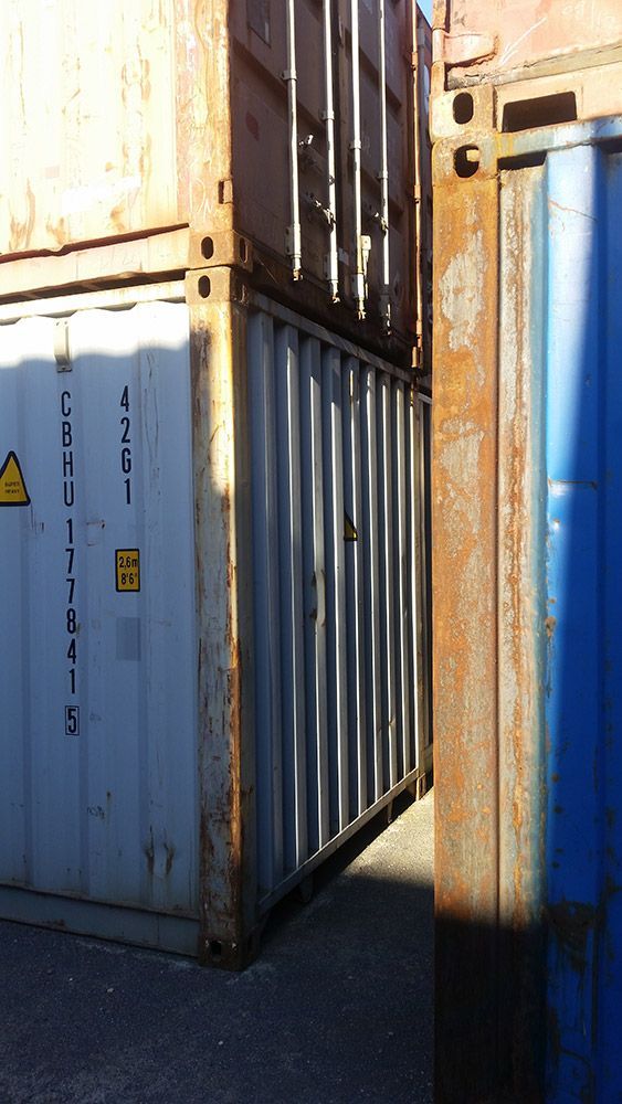 A Couple Of Shipping Containers Are Sitting Next To Each Other — Oz Shipping Containers in Newcastle, NSW