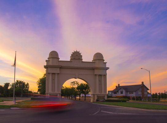 A Blurry Picture Of A Car Driving Past An Archway At Sunset — Oz Shipping Containers in Ballarat, VIC