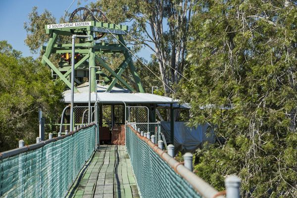 A Suspension Bridge Leading To A Building Surrounded By Trees — Oz Shipping Containers in Gympie, QLD