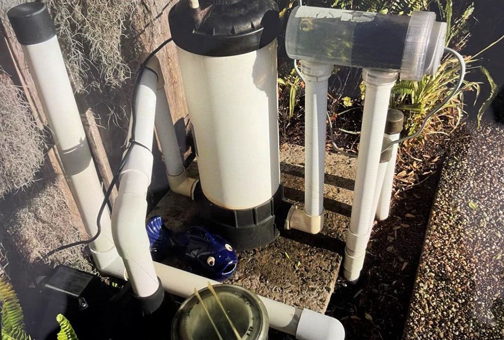 A Swimming Pool Filter is Sitting on Top of a Concrete Surface — Taree Pool Supplies in Forster, NSW