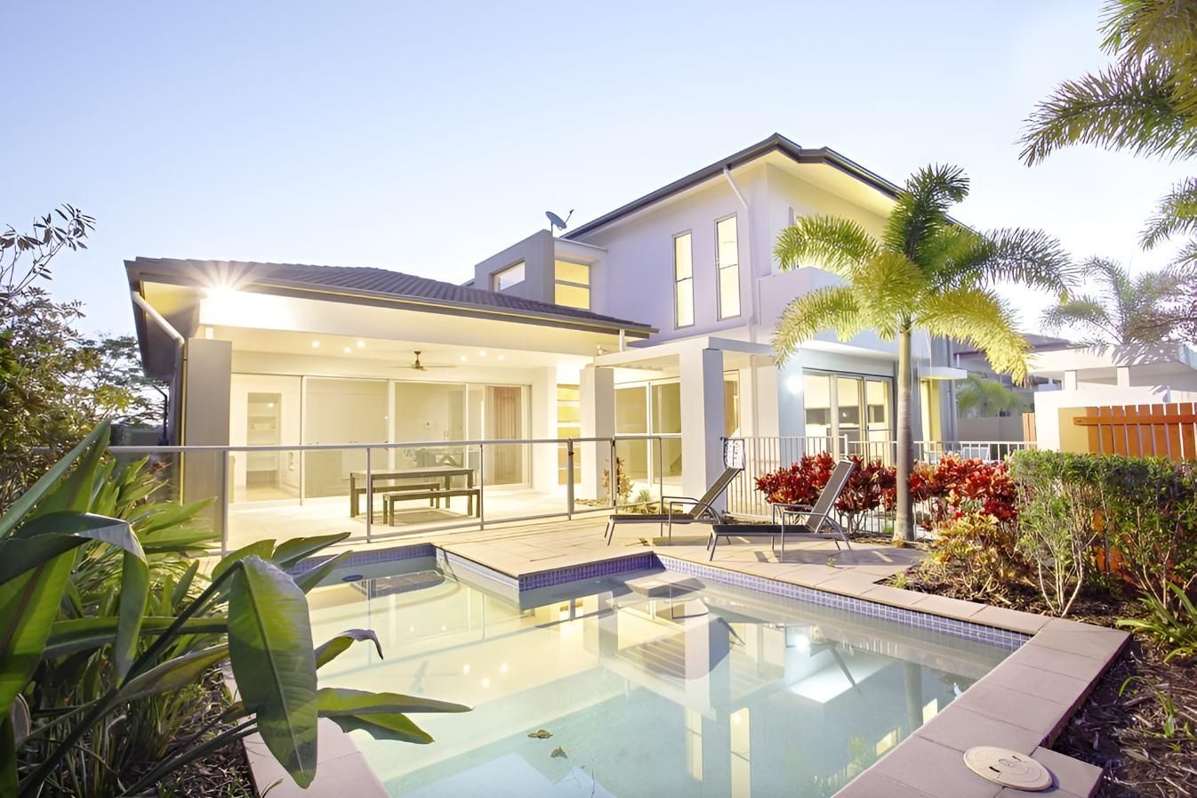 A House With a Swimming Pool in Front of It — Taree Pool Supplies in Taree, NSW