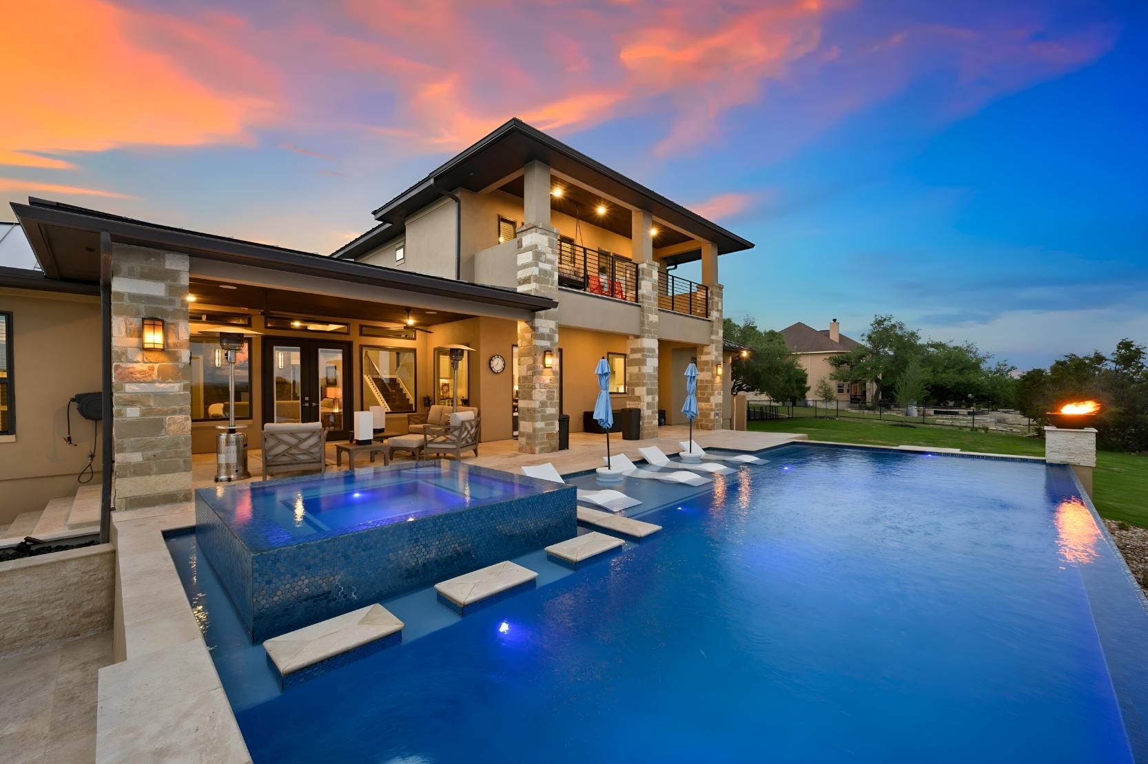 A Large House With a Large Swimming Pool in Front of It — Taree Pool Supplies in Taree, NSW