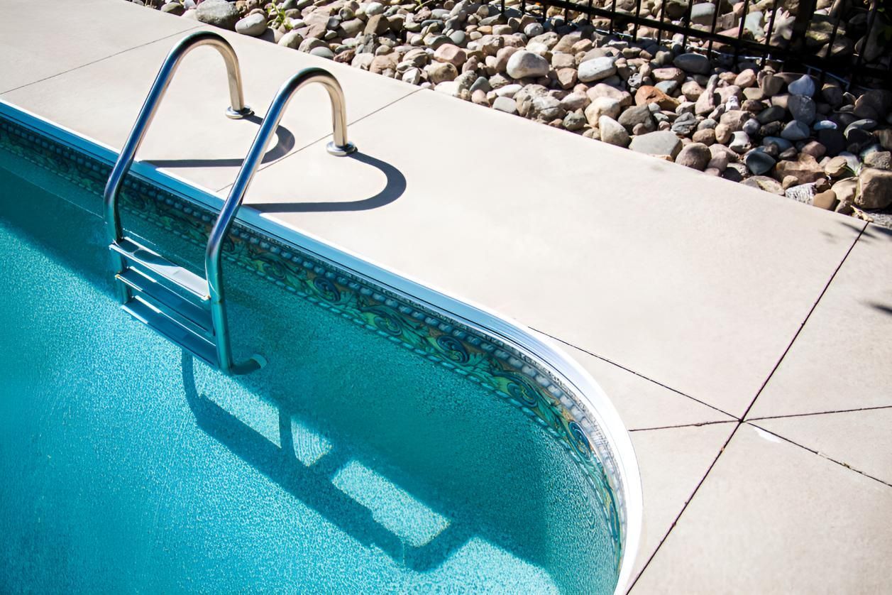 A Swimming Pool With a Heart Shaped Ladder in the Water — Taree Pool Supplies in Taree, NSW