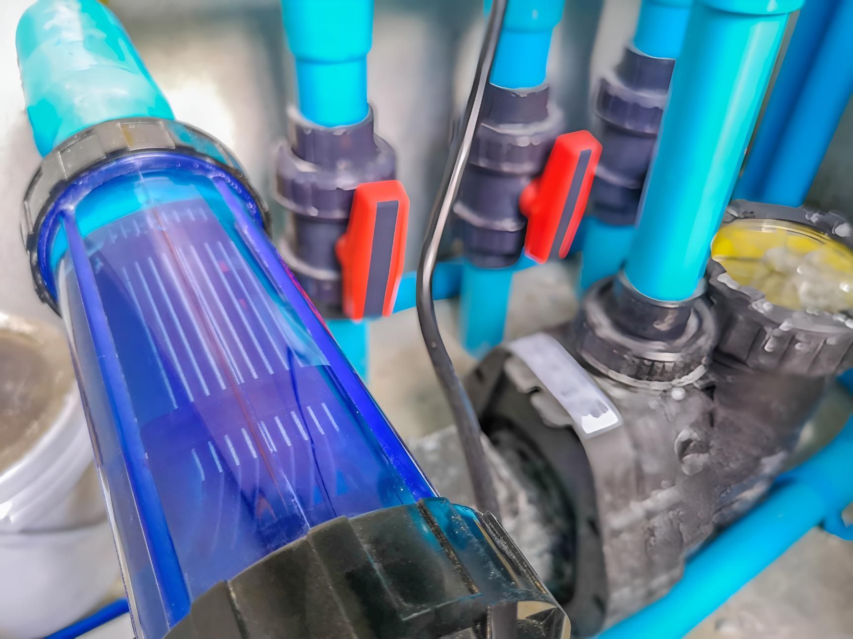 A Close Up of a Swimming Pool Pump Surrounded by Blue Pipes — Taree Pool Supplies in Forster, NSW