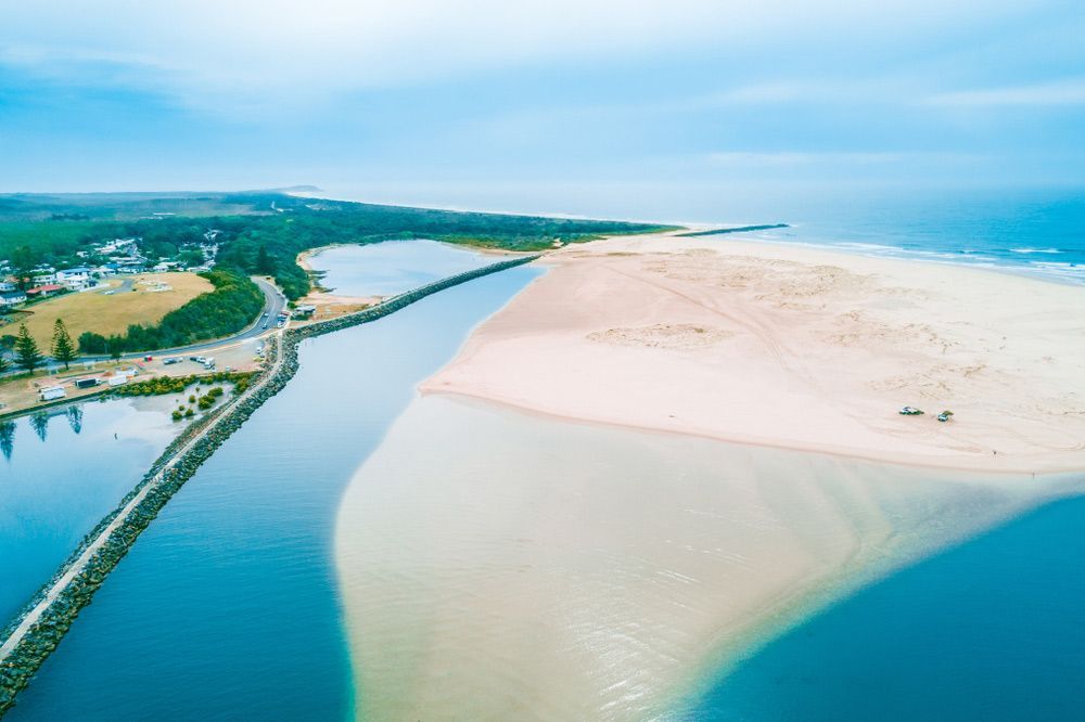 An Aerial View of a River and a Sandy Beach — Taree Pool Supplies in Harrington, NSW