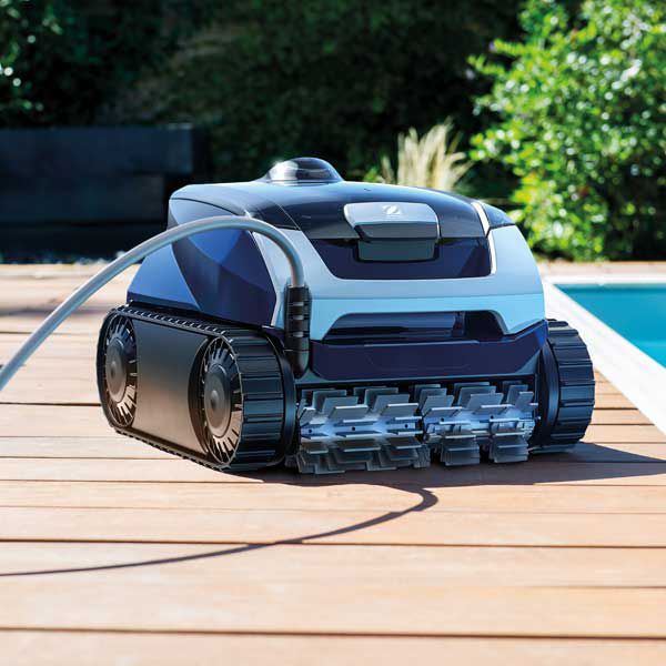 A Robotic Pool Cleaner is Sitting on a Wooden Deck Next to a Pool — Taree Pool Supplies in Taree, NSW