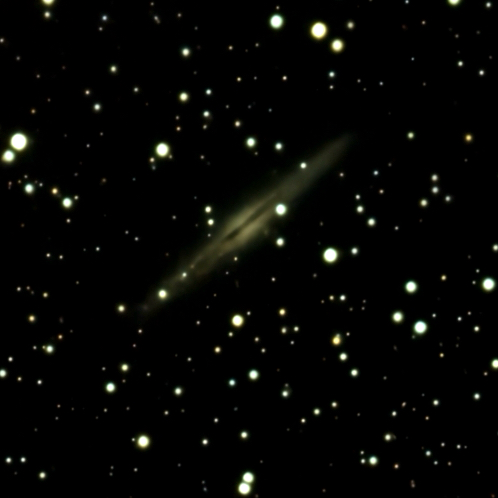 A starry night sky with a faint diagonal nebula or comet-like streak.