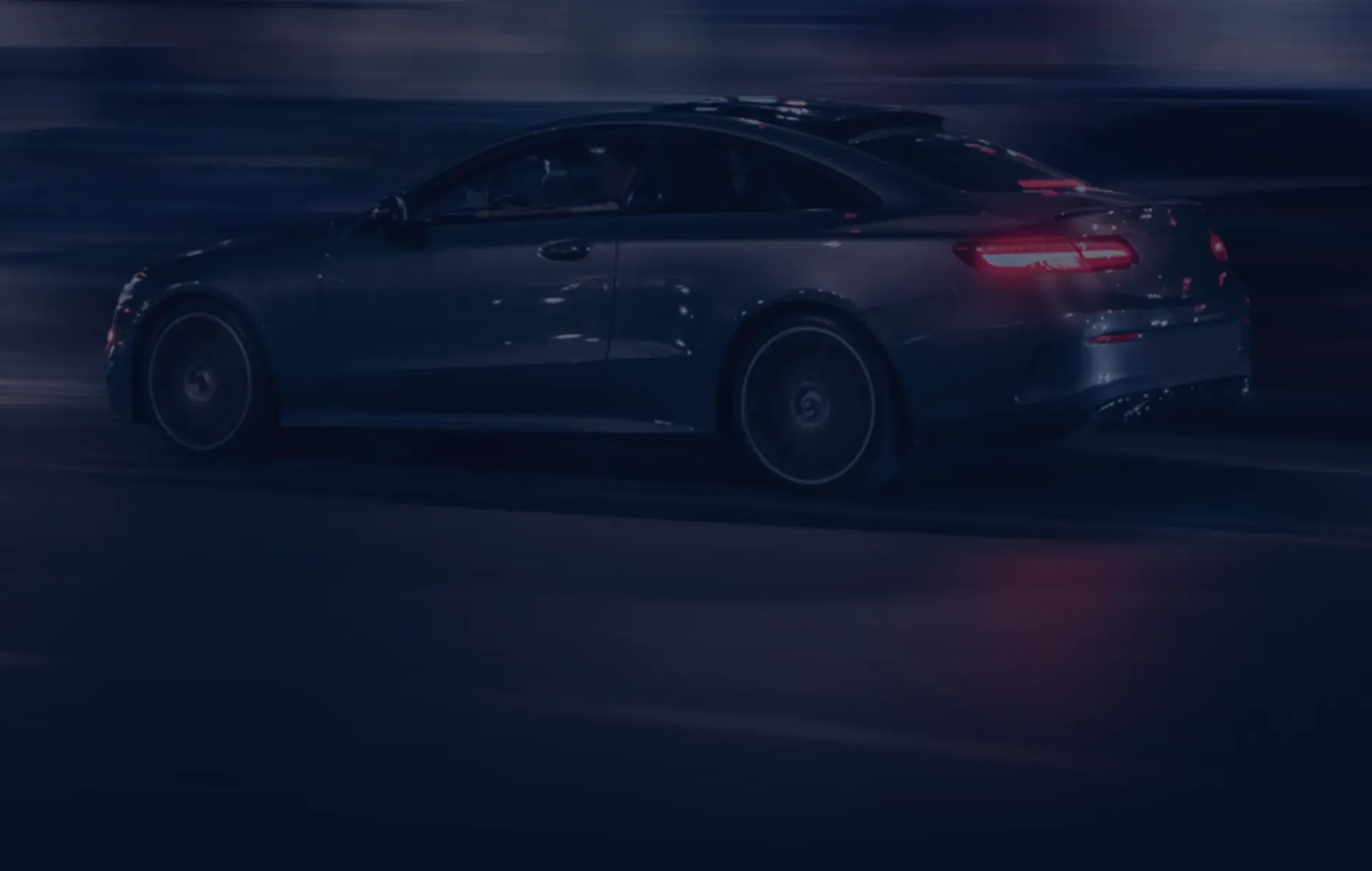 Vehicle driving quickly down street in background | Firo's Autohaus