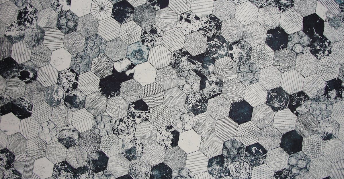 A close up of a black and white quilt with a hexagon pattern.