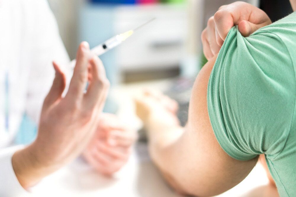 A Person Is Getting a Vaccine from A Doctor — Tuncurry Medical Centre In Tuncurry, NSW