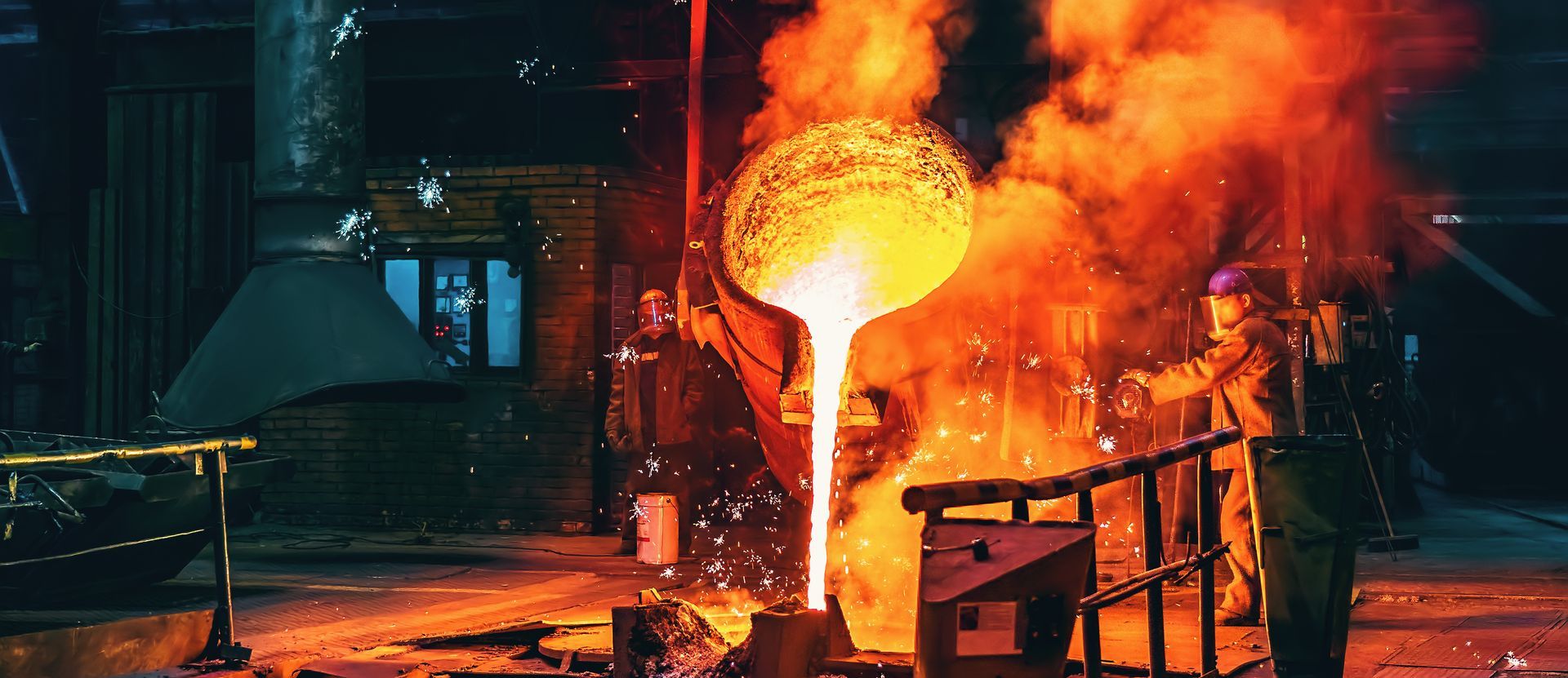 Liquid iron molten metal pouring in container, industrial metallurgical factory.