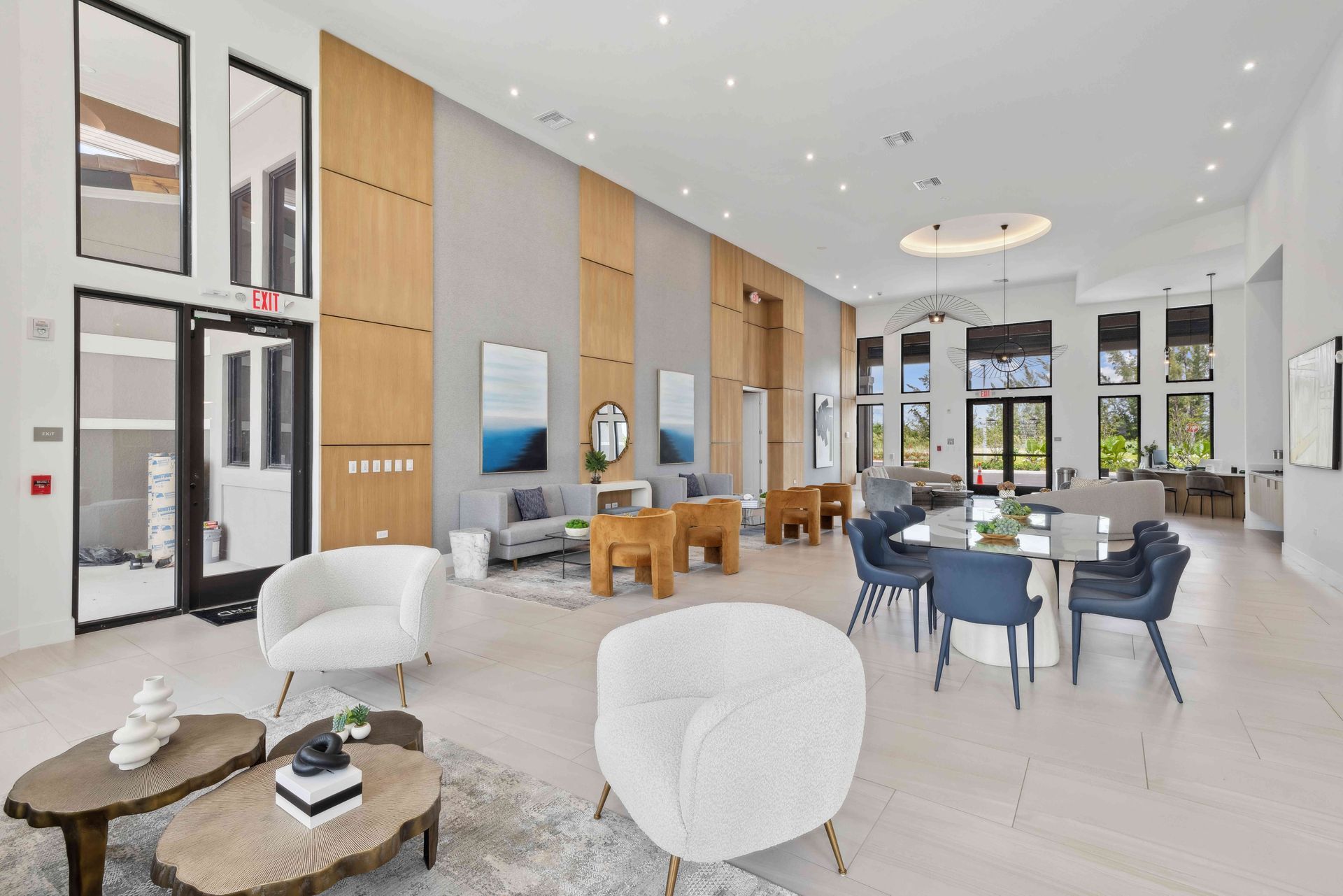 Spacious, modern lobby with seating areas, wooden paneling, and large windows.