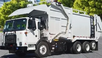 White refuse truck powered by custom wiring harnesses and cable assemblies for heavy-duty vehicle OEMs.