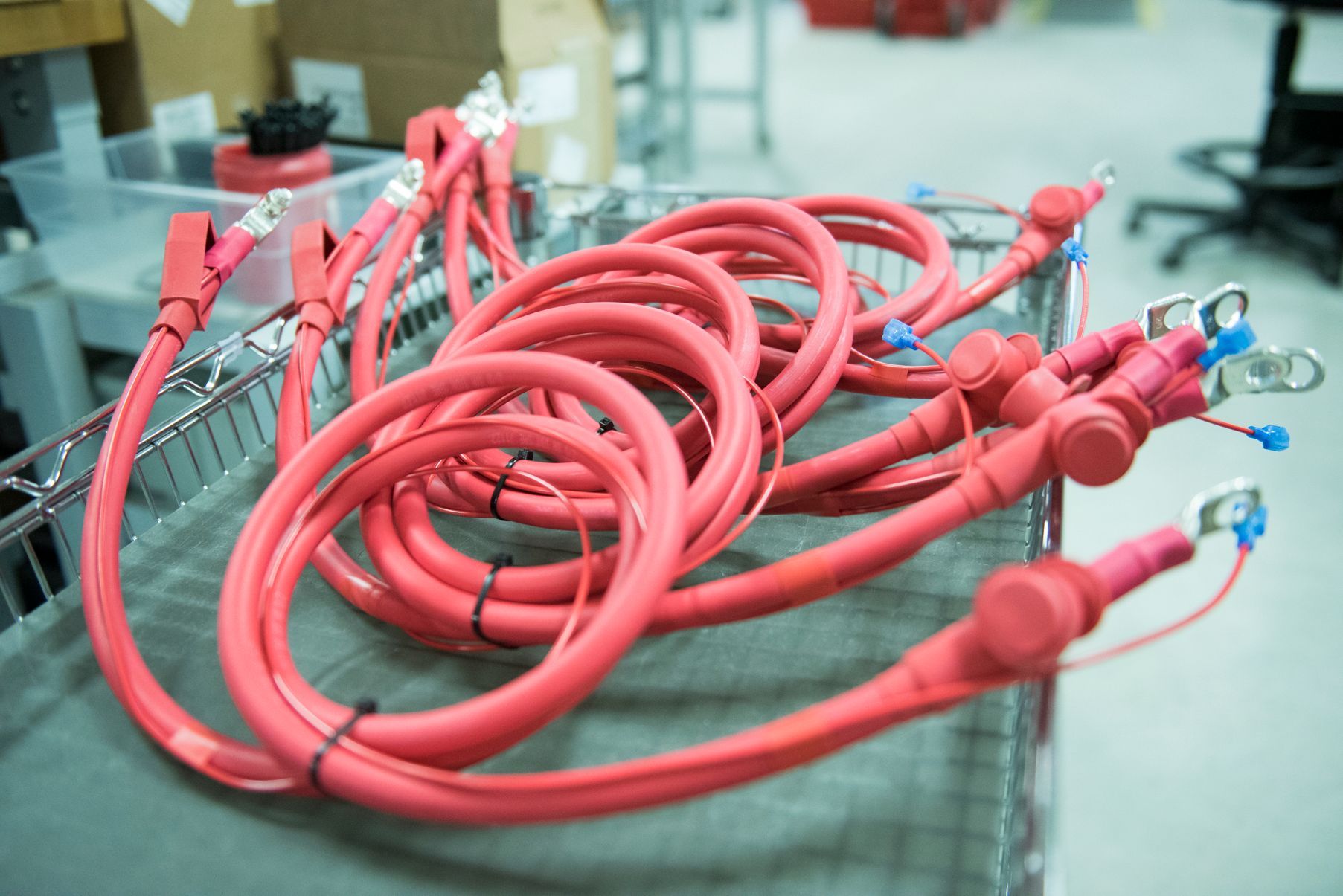 Red battery cable assemblies manufactured by Kato Cable for high-performance OEM applications.