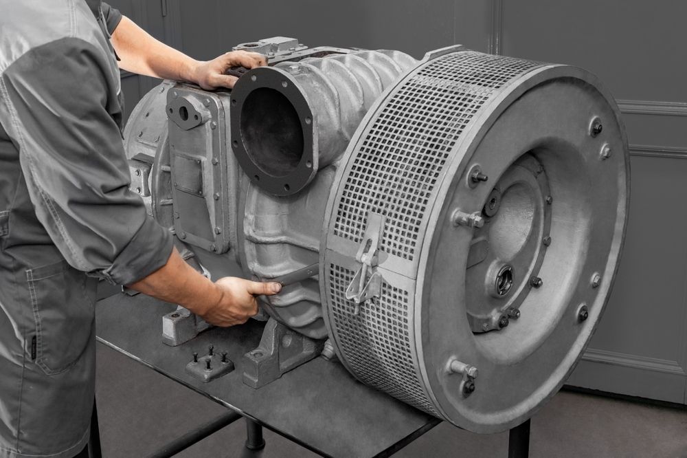 Person handling a large industrial machine, likely for maintenance or installation.