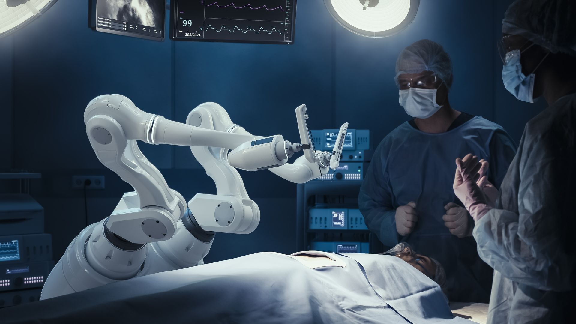 Two surgeons in a dimly-lit operating room.