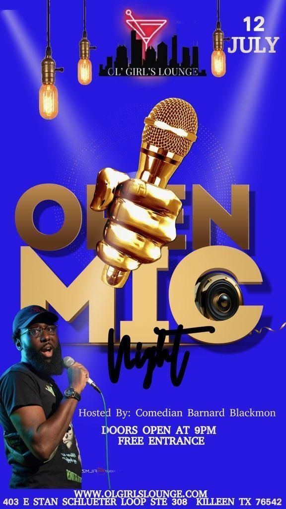 A man is holding a microphone in his hand on a blue background.