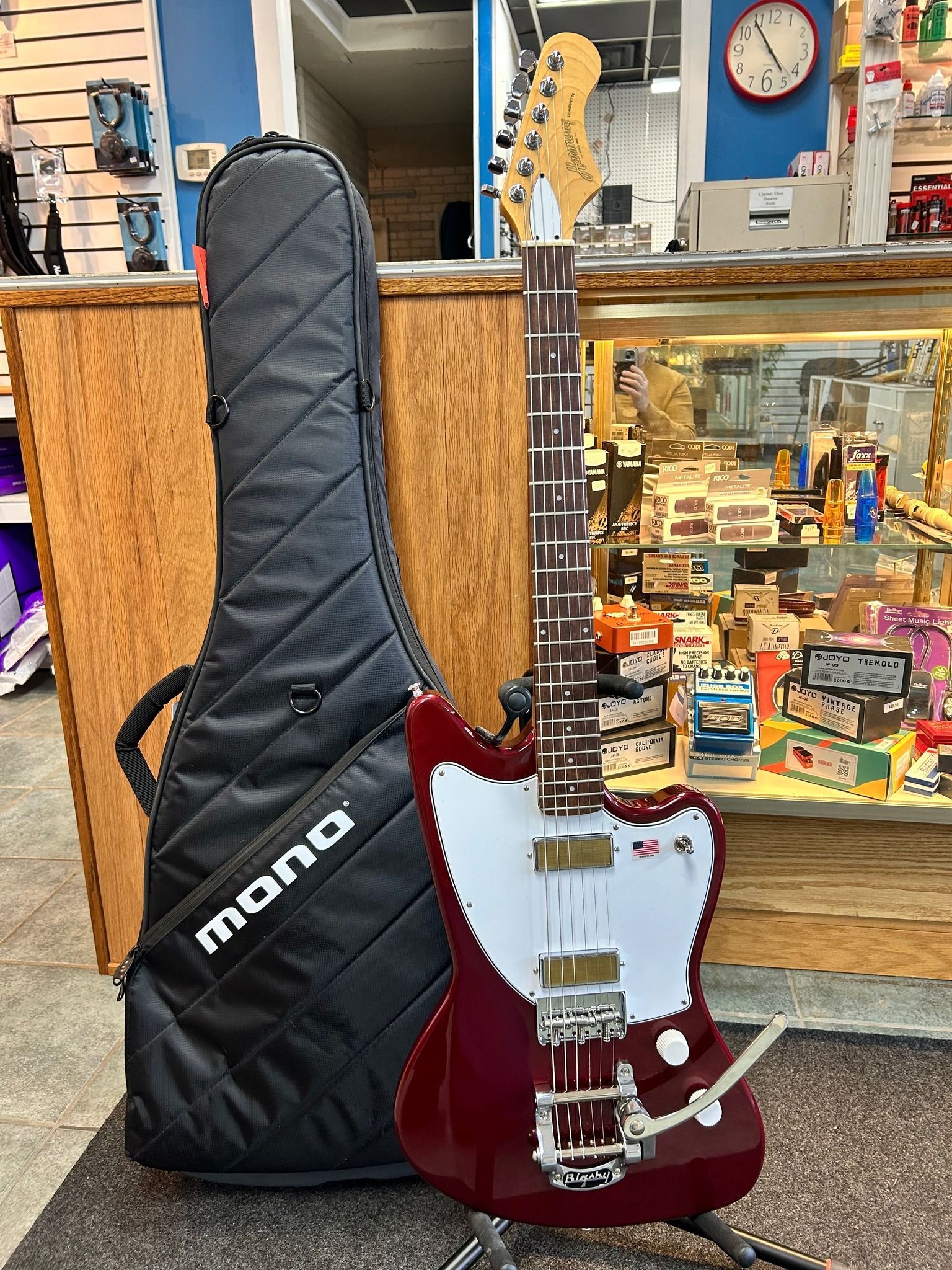 Red electric guitar next to a black
