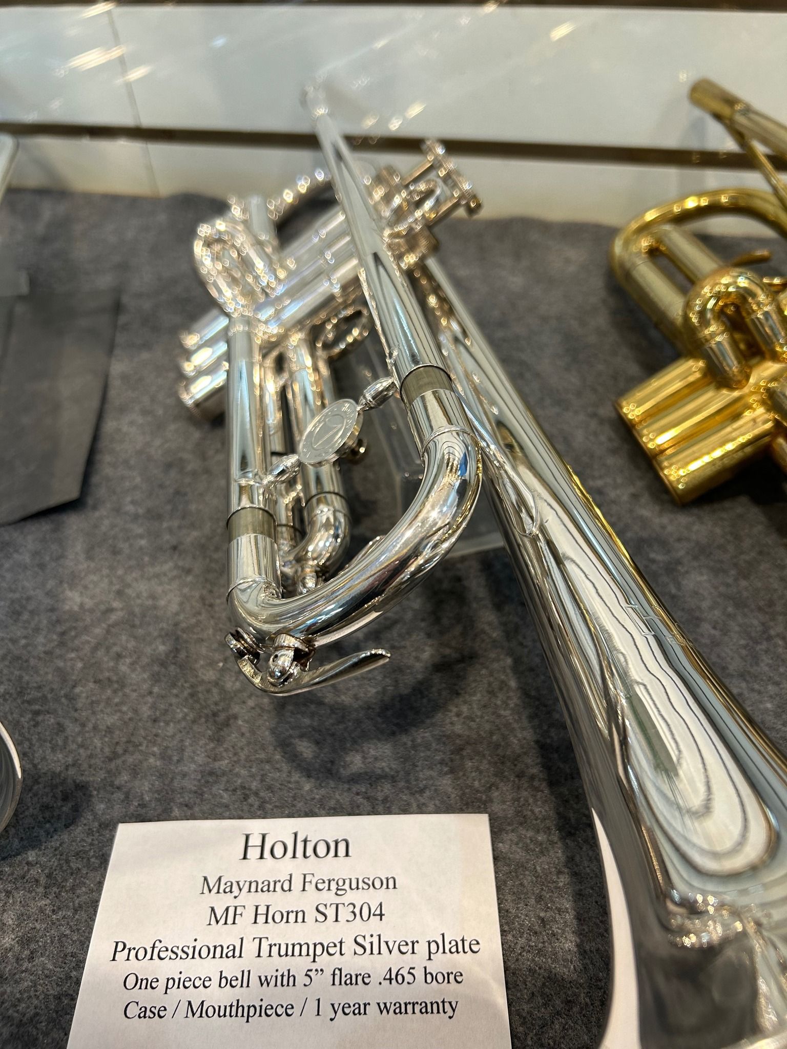 Silver trumpet with a label identifying it as a Holton Maynard Ferguson model.