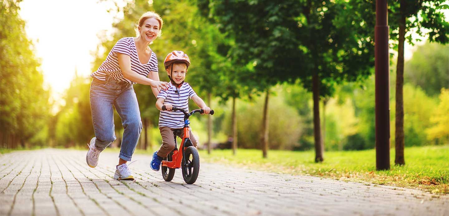 Mother teacher child son to ride a bike