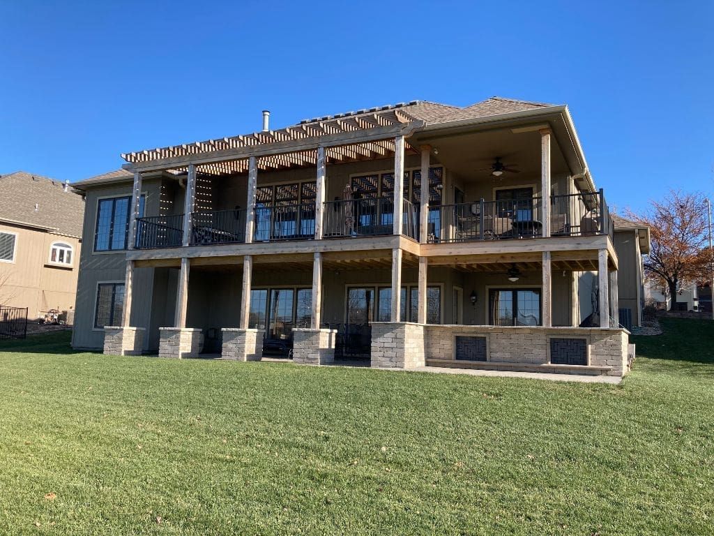A large house with a lot of windows and a large lawn in front of it.