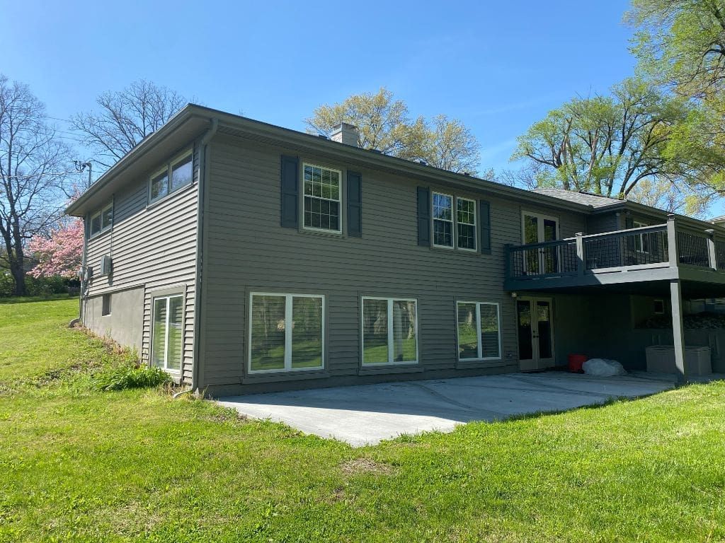 A large house with a large lawn in front of it.