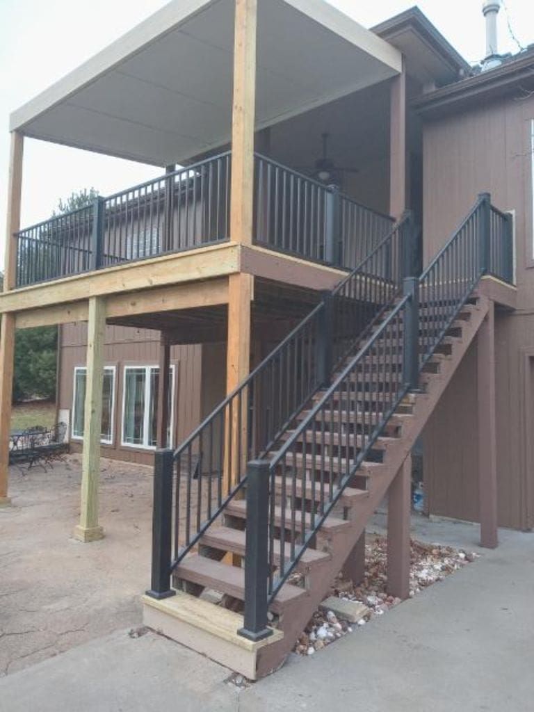 A house with a deck and stairs leading up to it.