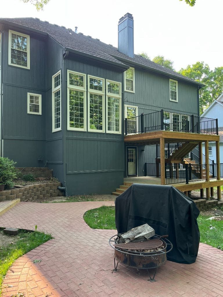 A large house with a fire pit in front of it.