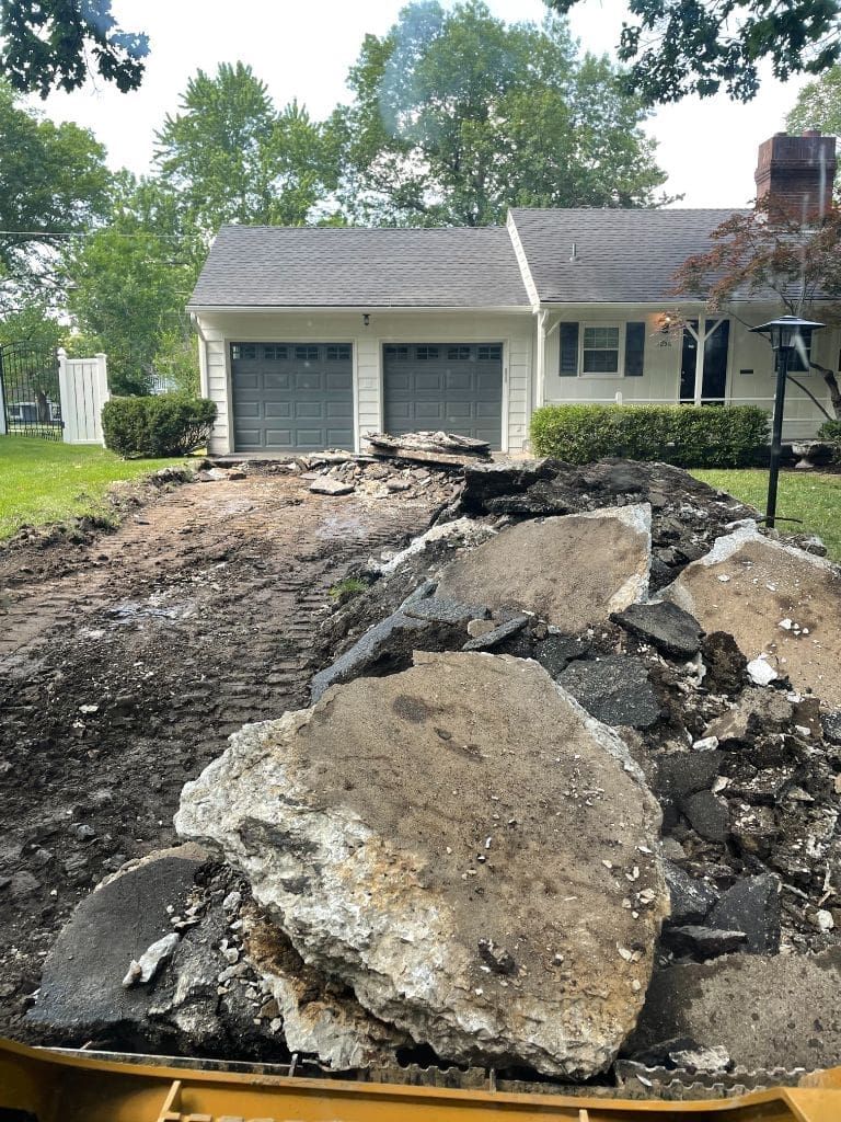 A pile of rocks is sitting in front of a house.