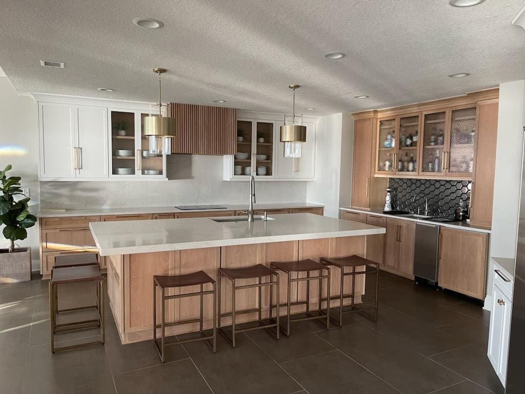 A kitchen with a large island and stools