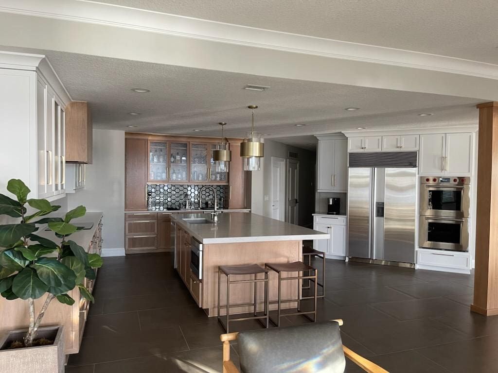 A kitchen with stainless steel appliances and wooden cabinets