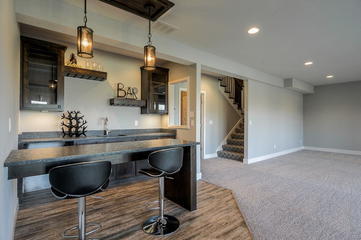 There is a bar in the basement of a house.