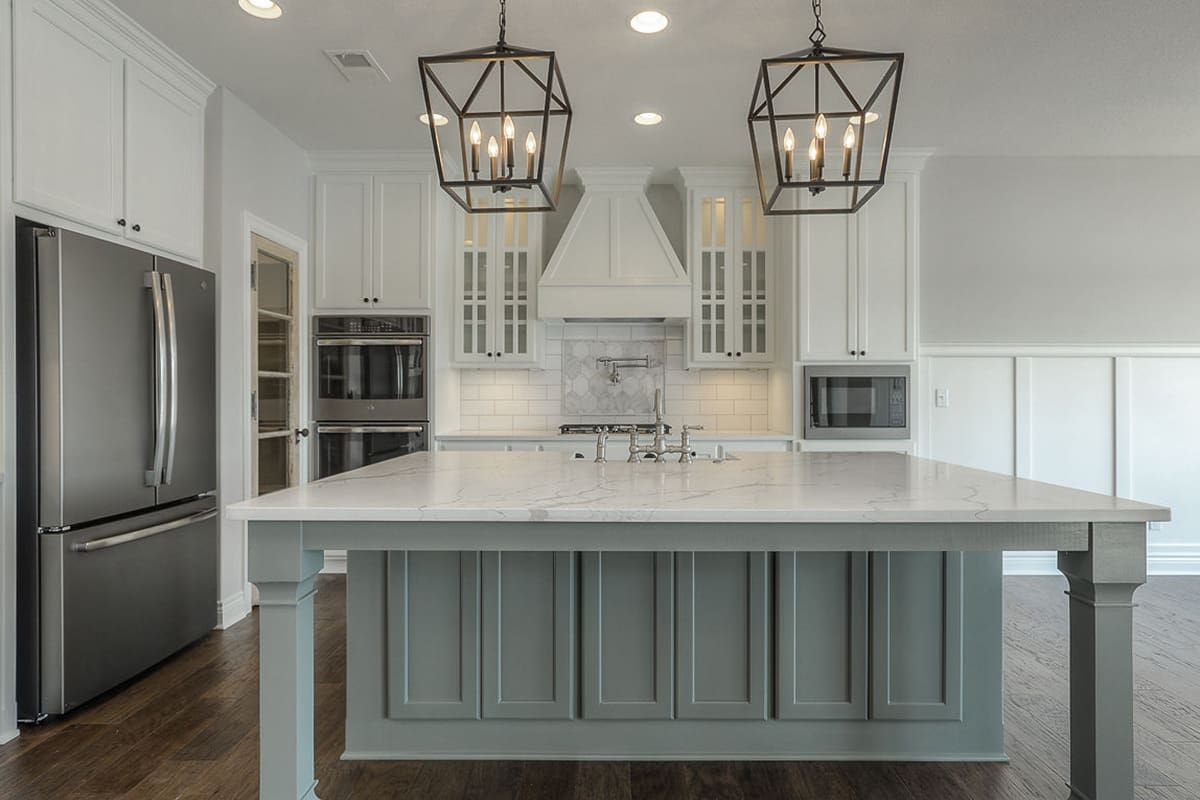 There is a large island in the middle of the kitchen.