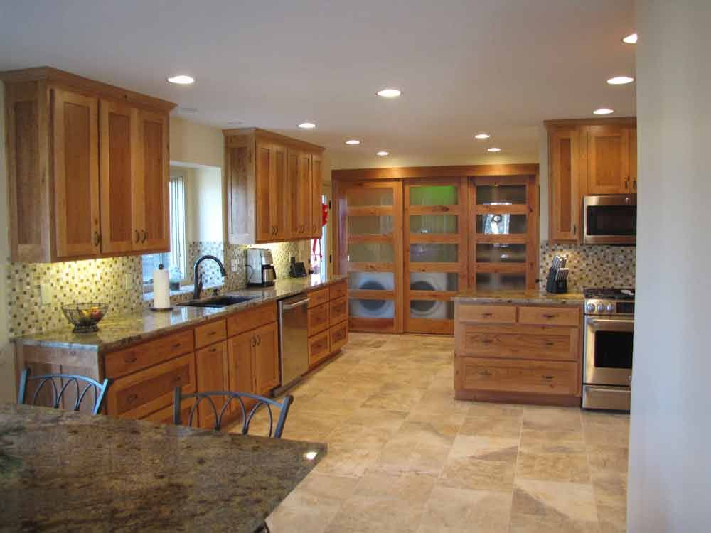 A kitchen with wooden cabinets and granite counter tops
