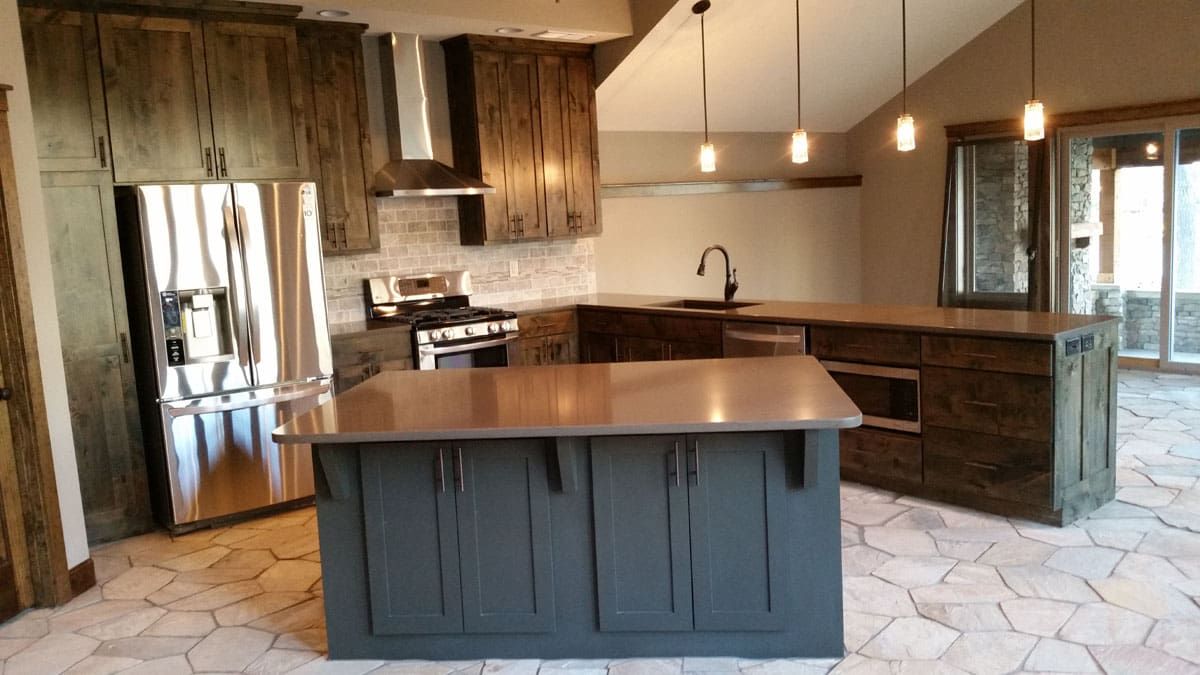 A kitchen with a large island and stainless steel appliances.