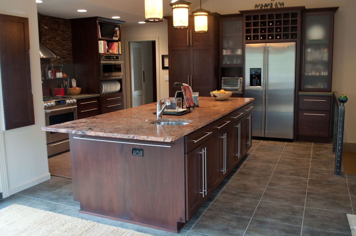 A kitchen with a large island and stainless steel appliances