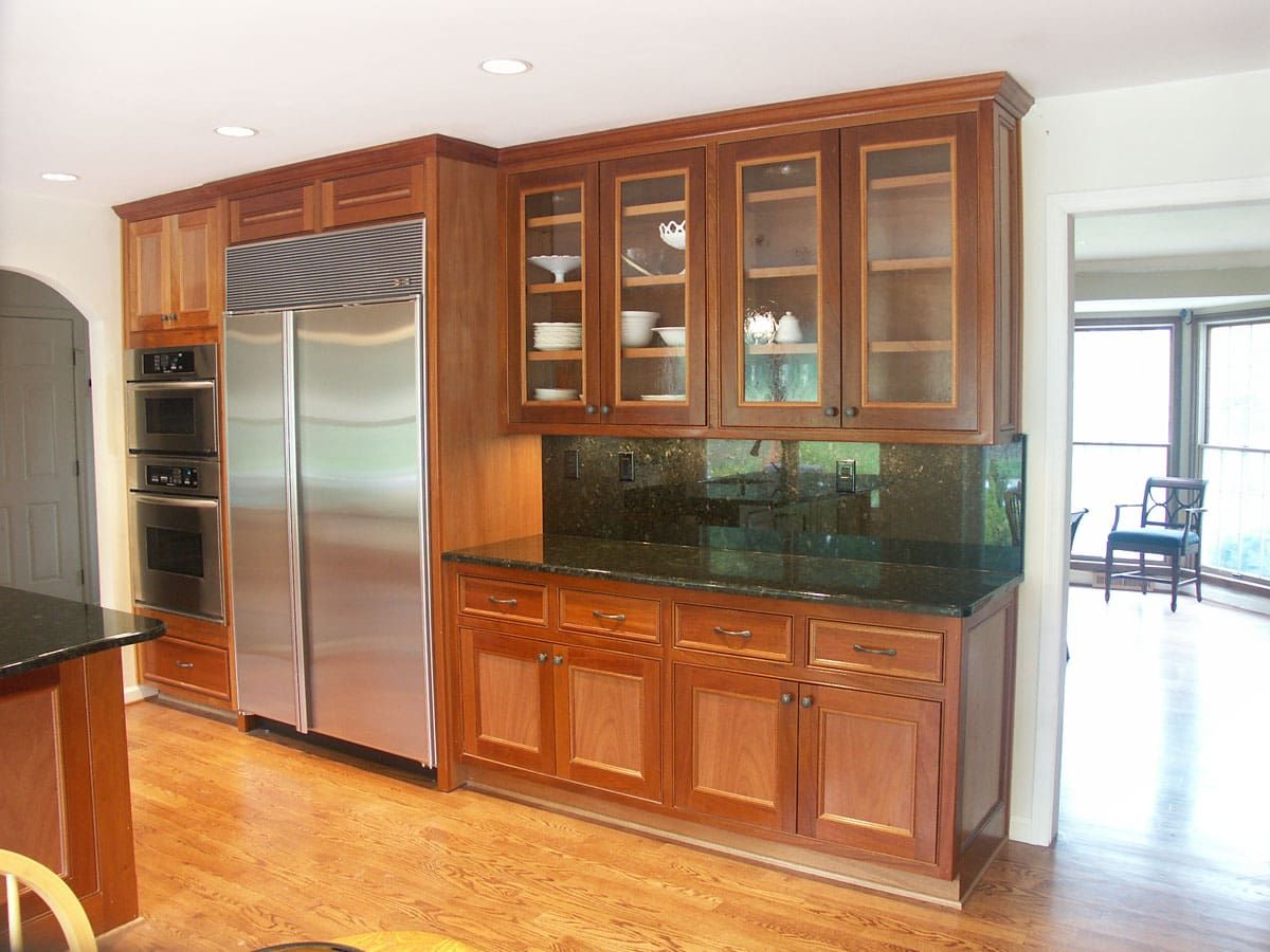 A kitchen with stainless steel appliances and wooden cabinets