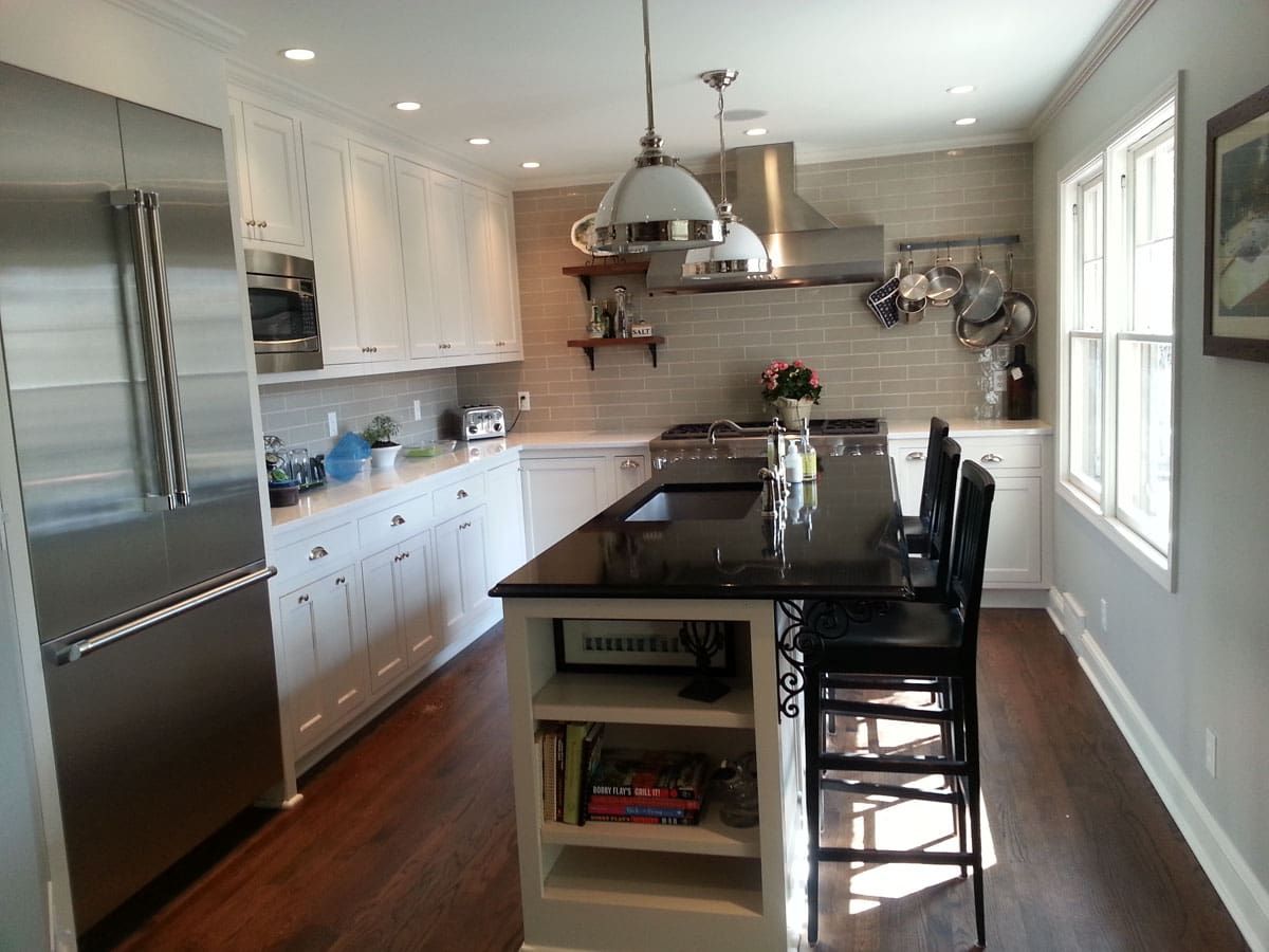 A kitchen with stainless steel appliances and white cabinets