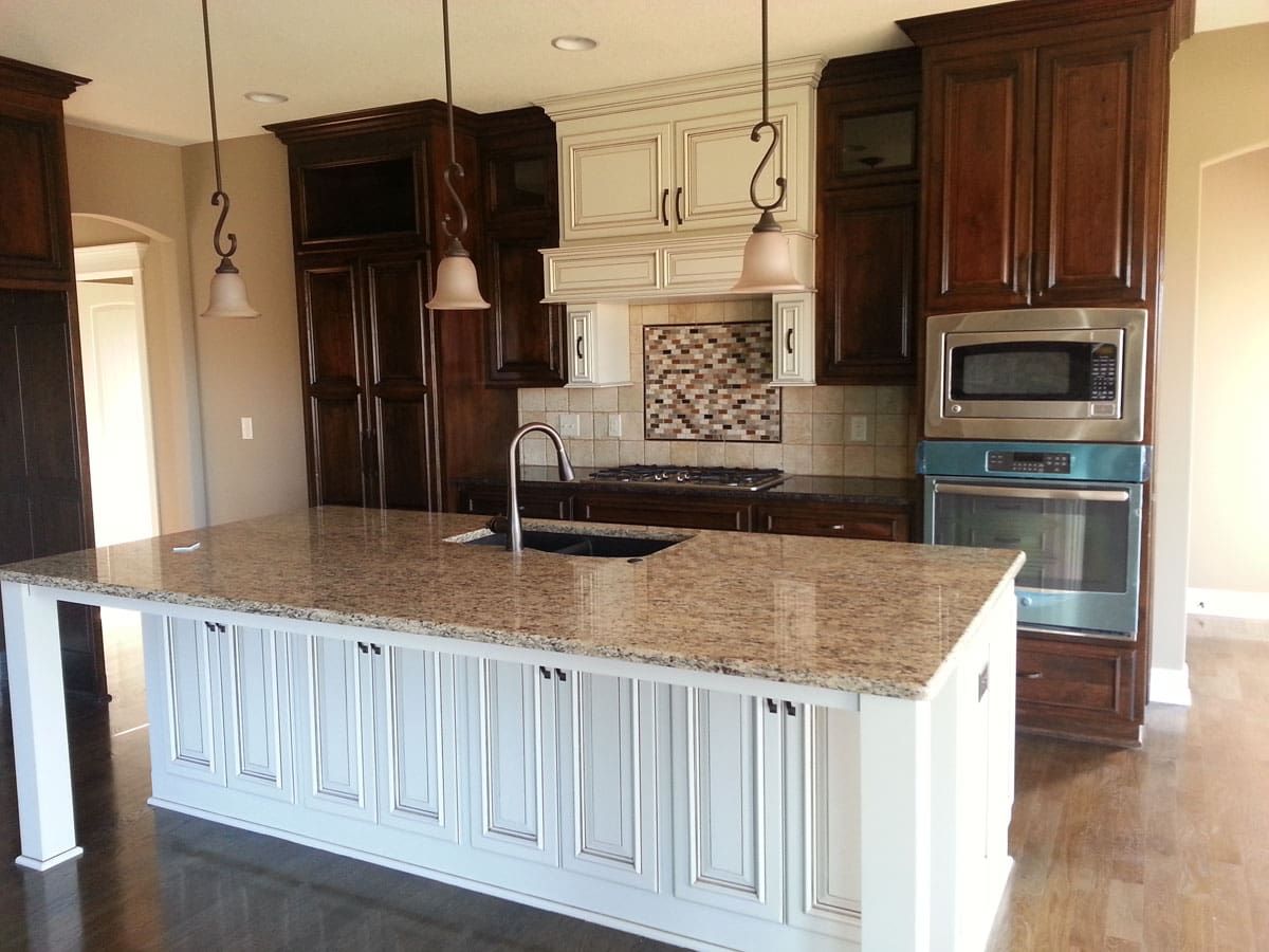 A kitchen with granite counter tops and stainless steel appliances