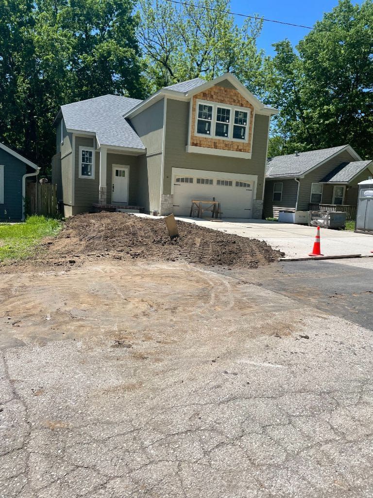 A house with a lot of dirt in front of it.
