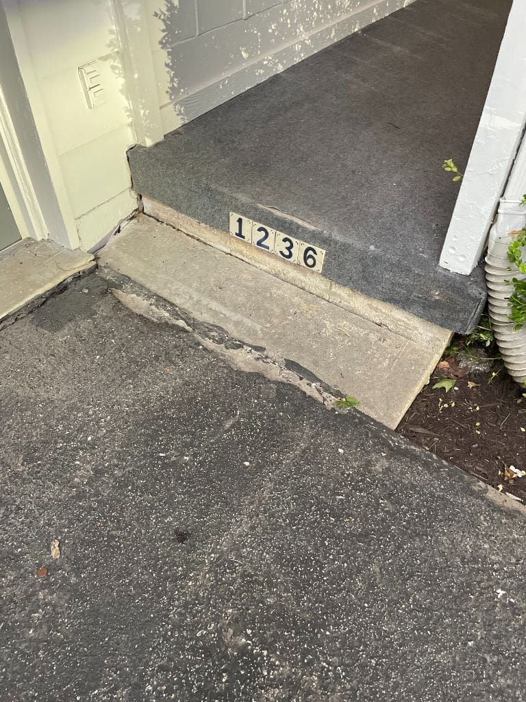 A concrete step with the number 1236 on it.