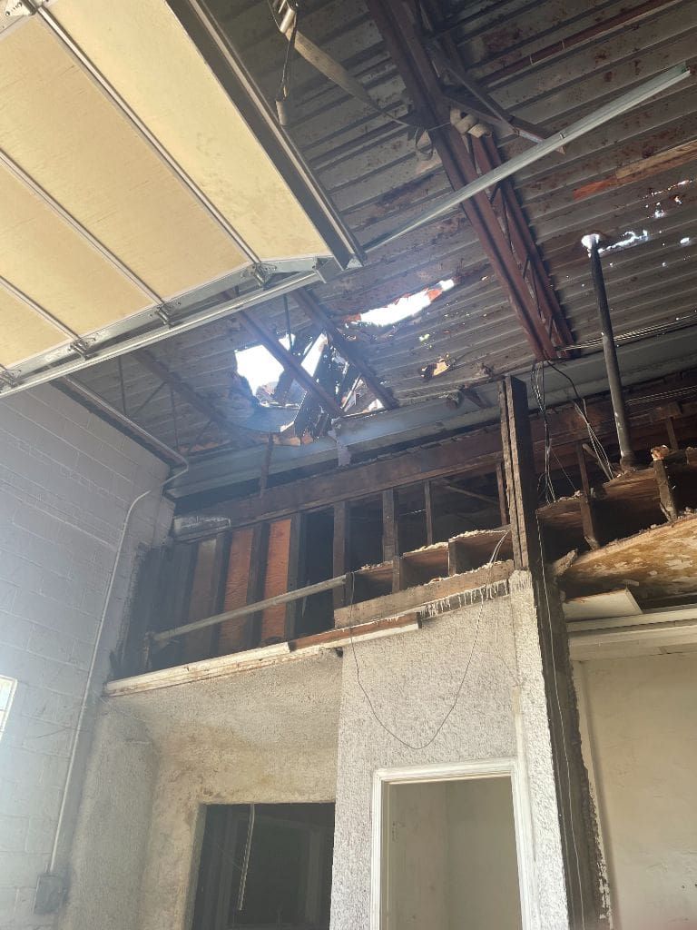 There is a hole in the ceiling of a building.