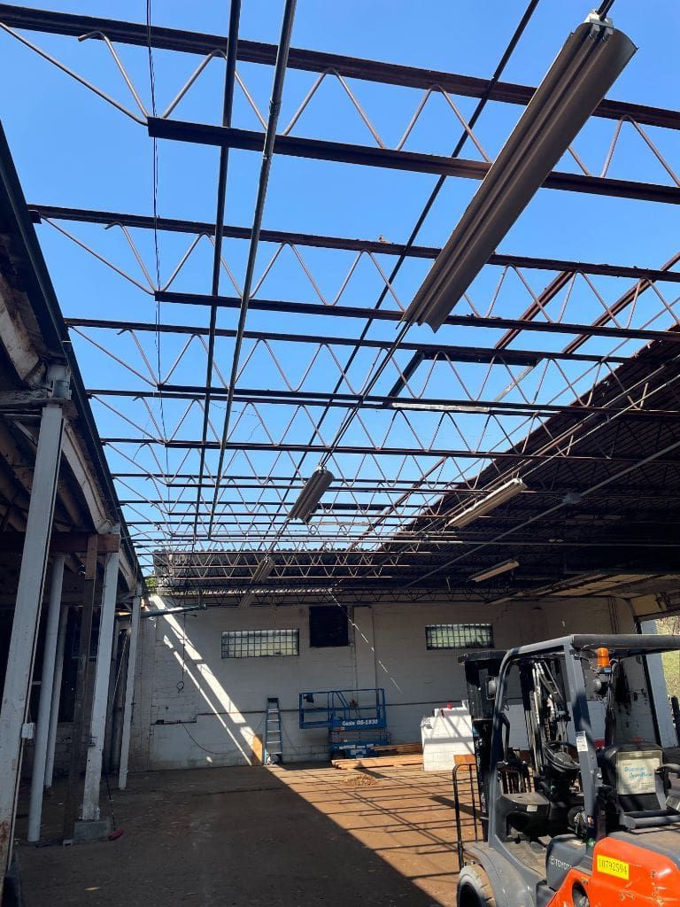 A forklift is parked in an empty warehouse
