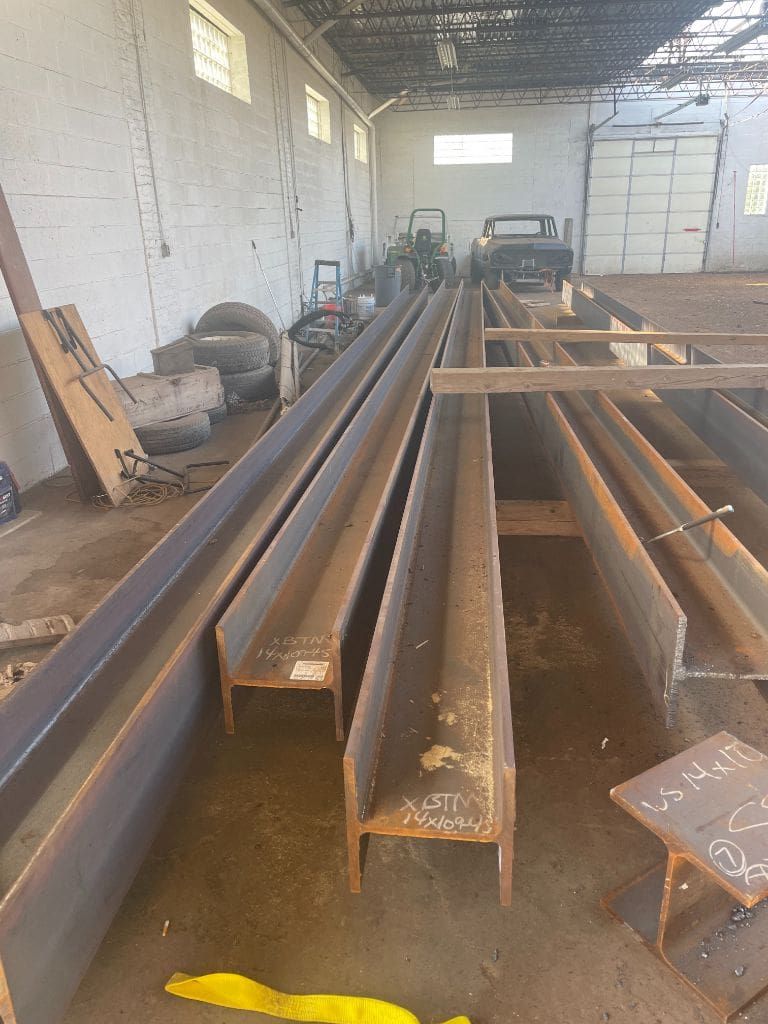 A bunch of metal beams are sitting in a warehouse.