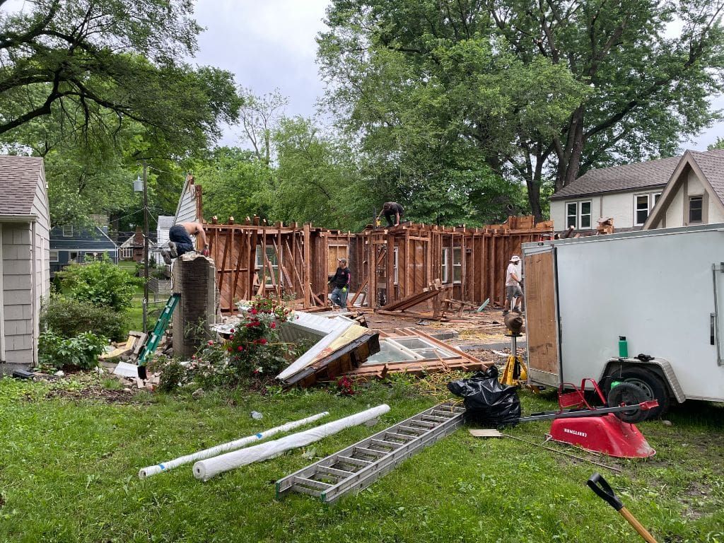 A house is being demolished in the backyard of a house.