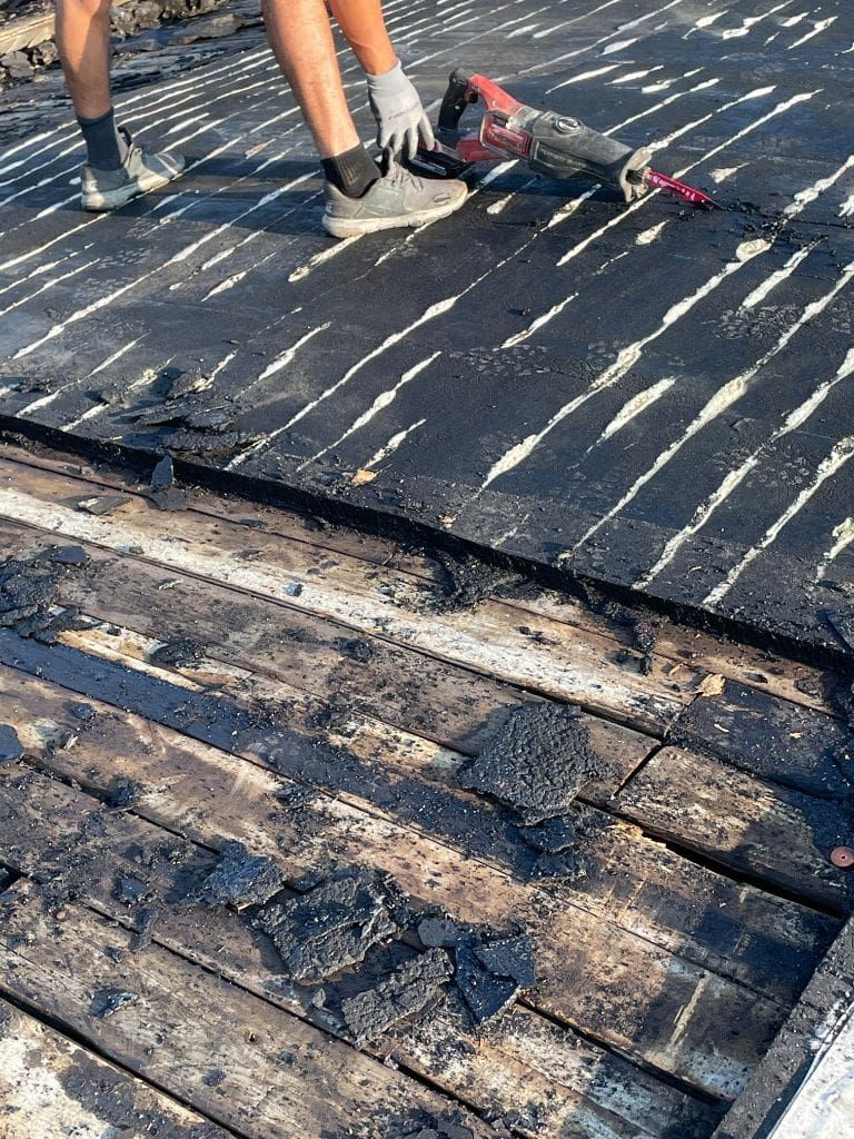 A person is cutting a piece of wood with a saw.