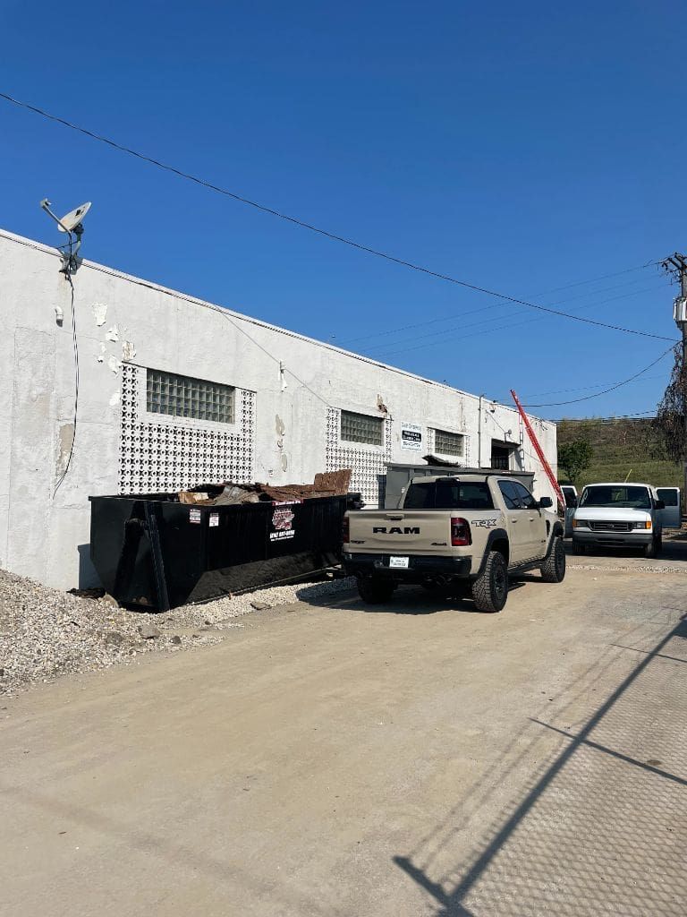 A truck is parked in front of a building.