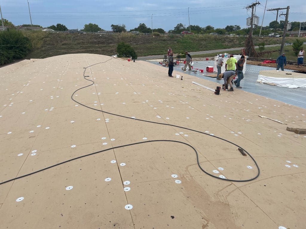 A group of people are working on a roof.