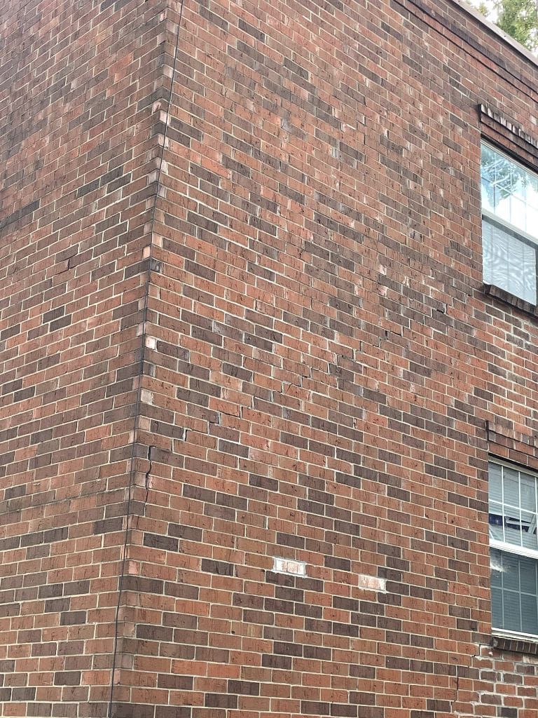 A close up of a brick building with a window.