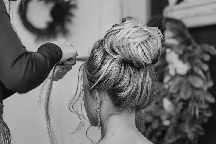 Hairdresser creates complex and beautiful hairstyle